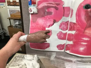 Hand next to figurine reference